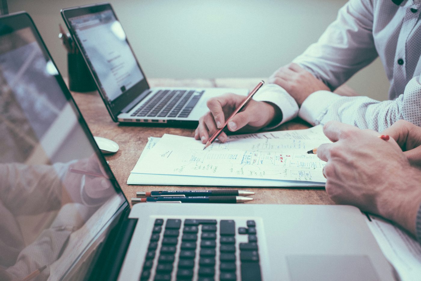 Advisors working through a strategy plan together at a desk